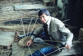 young Allan H Palecek holding a partially completed basket
